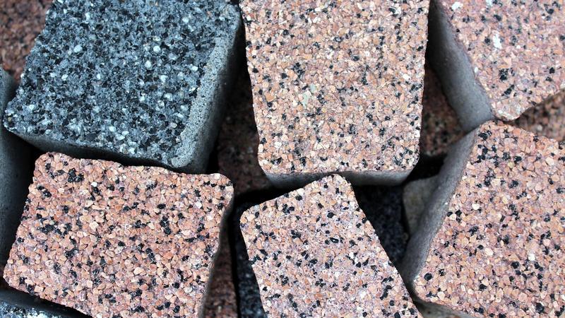High-pressure washing removing grime from commercial concrete